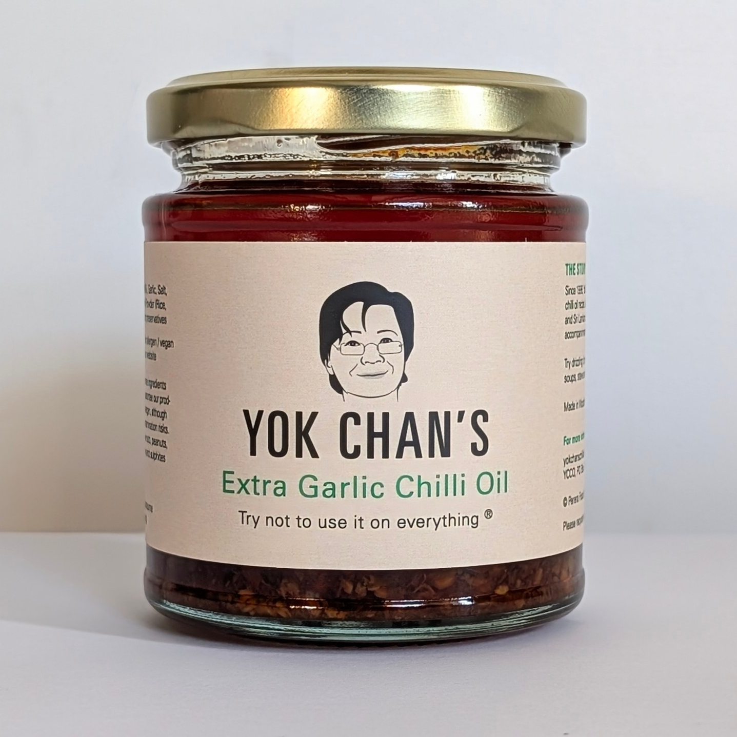 A jar of garlic chilli oil in a studio setting