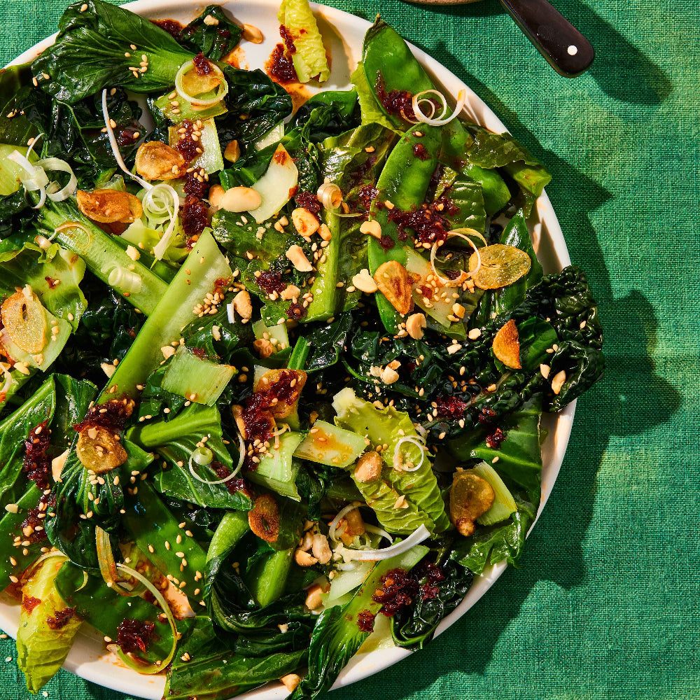 fried greens with garlic, sesame seeds in a bowl with chilli oil