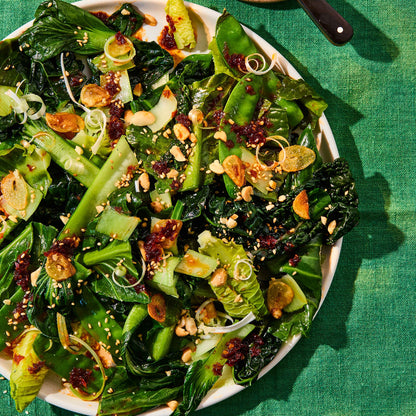 fried greens with garlic, sesame seeds in a bowl with chilli oil