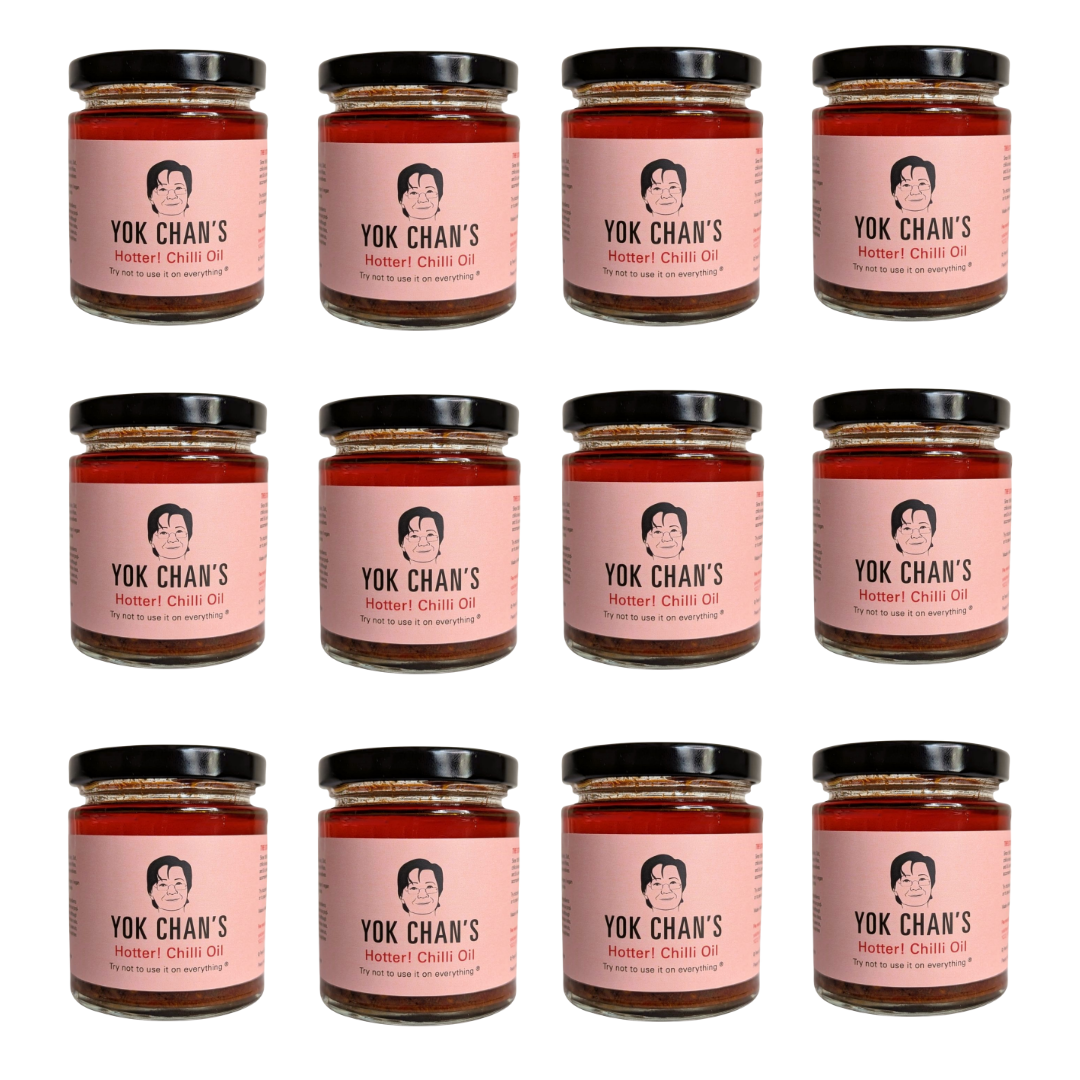 Twelve glass jars of Yok Chan's Hotter Chili Oil arranged in a 3x4 grid on a plain white background. Each jar has a pink label with a black lid and shows the brand name and product name clearly.