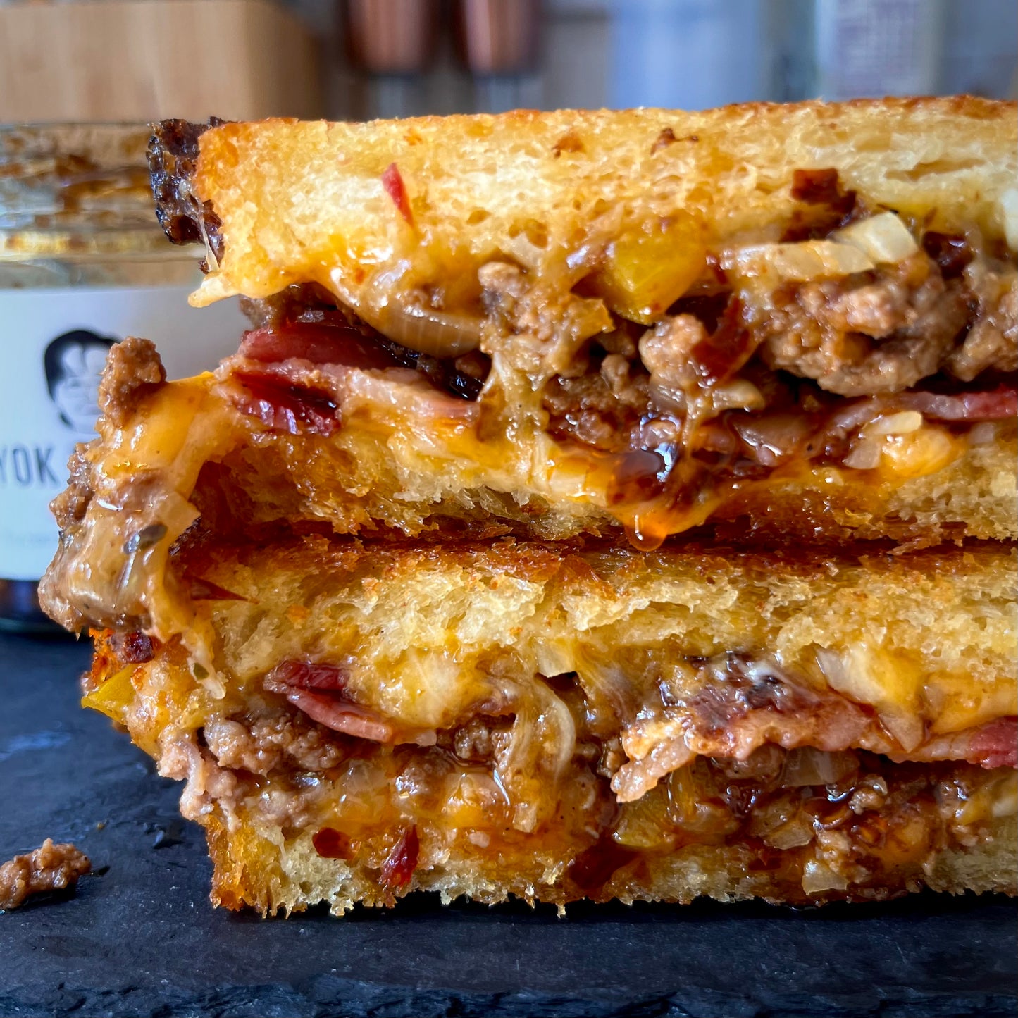close-up of toastie with meat, onions and chilli oil