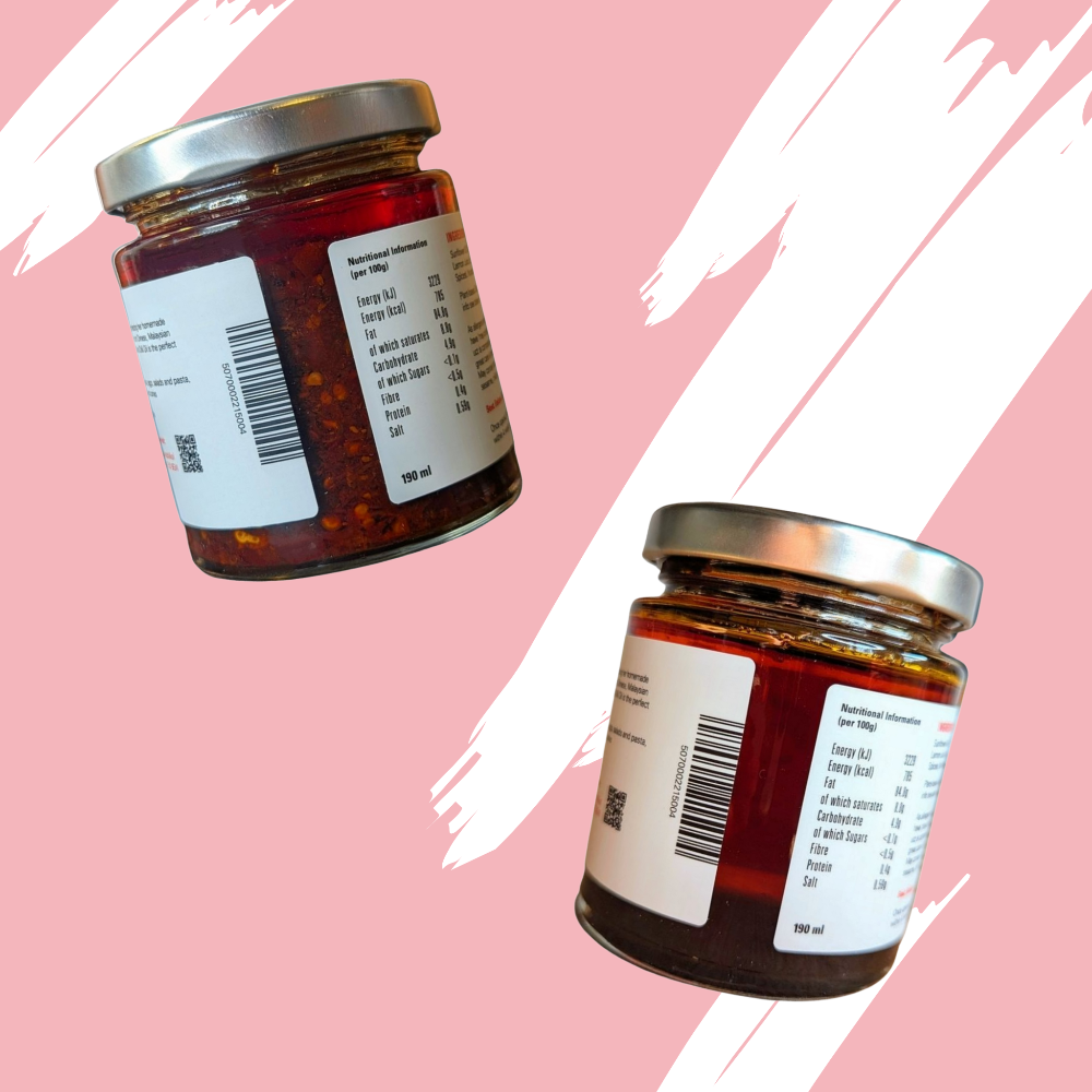 Two jars of chilli oil with labels on a pink background