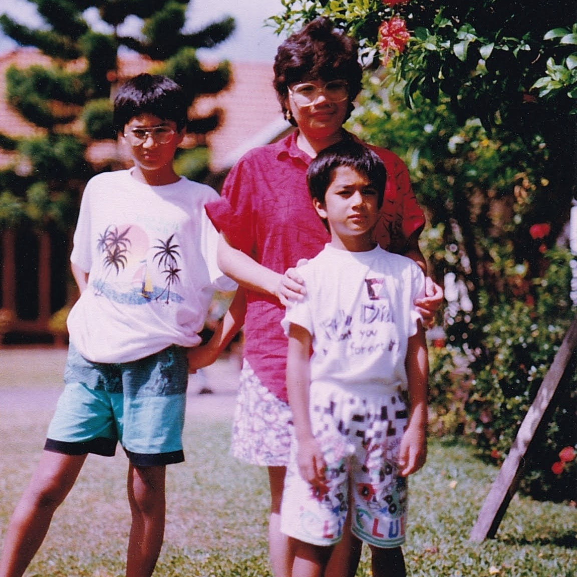 Family standing near flower bush