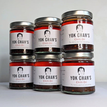 Six jars of chilli oil in a line
